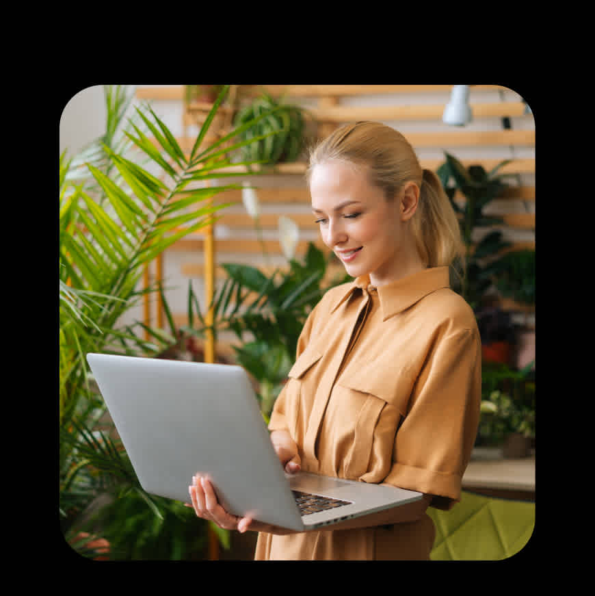 A female advertiser checks her laptop smiling