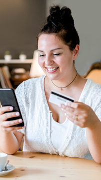 Person managing payments on mobile, representing flexible Snapchat ads pricing with full control over ad spend.