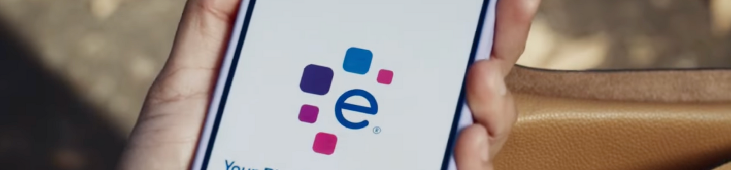 Close up of a person’s hand holding a smartphone opened to the Experian app.