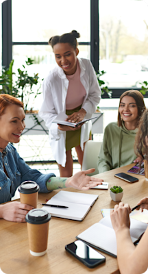 A group of people working for a publisher sit around a table