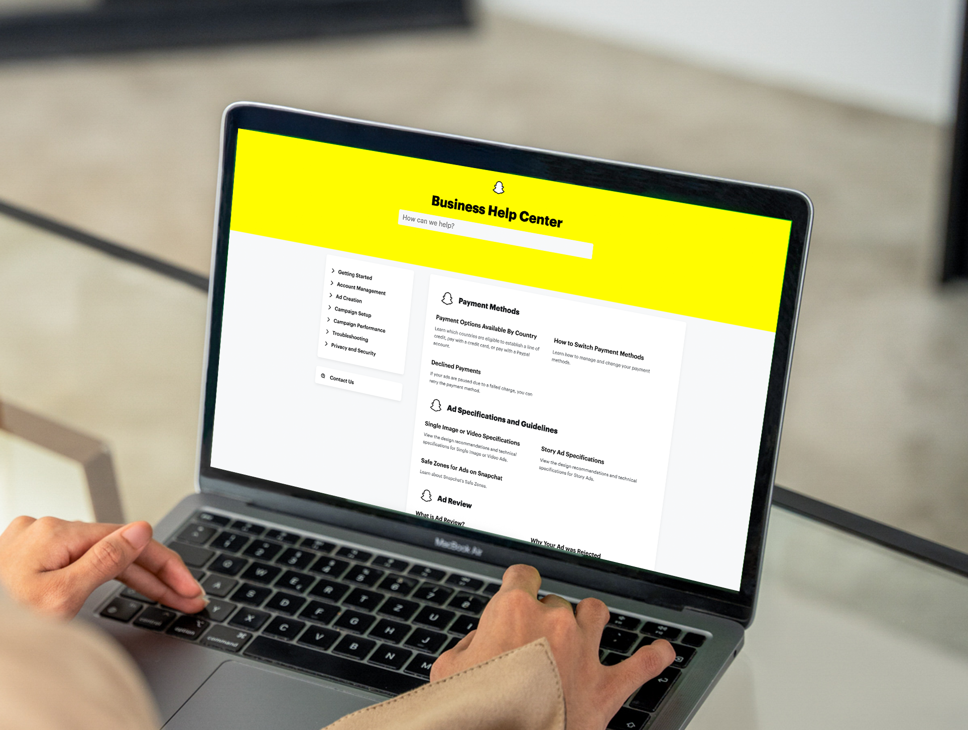 A user searches the Snapchat Business Help Center website on a laptop