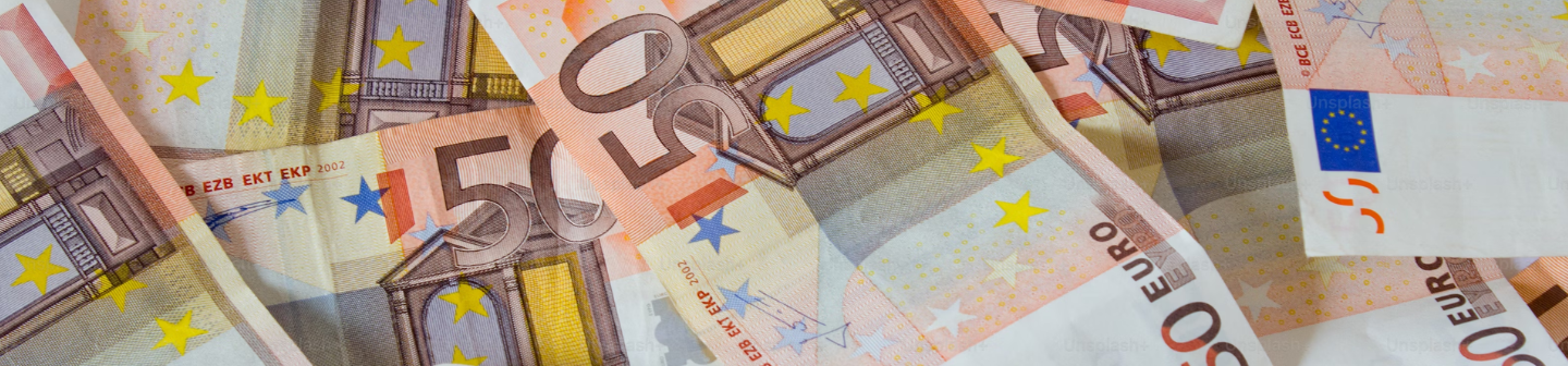 A top down view of a pile of Euro bills.